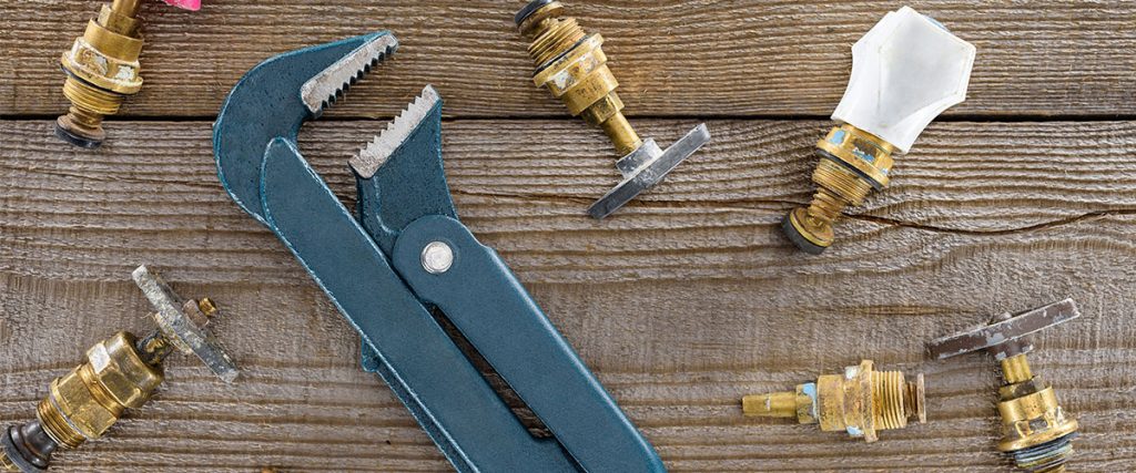 image with a wrench on table with other plumbing fixtures