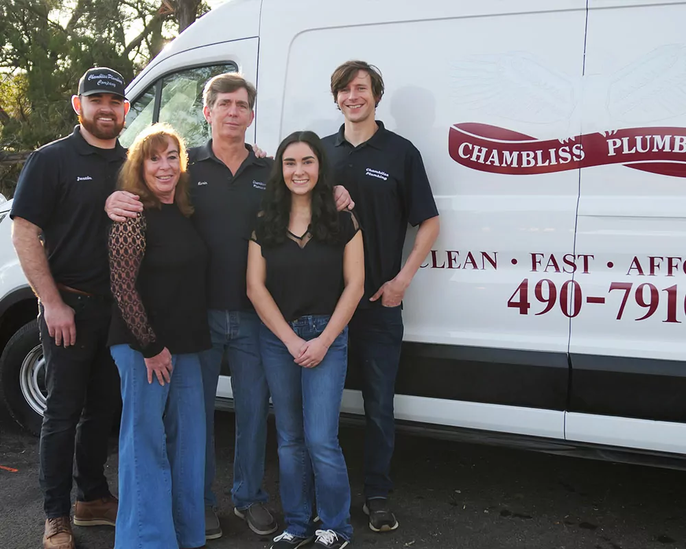 Plumbing Company owners / family image next to their business van