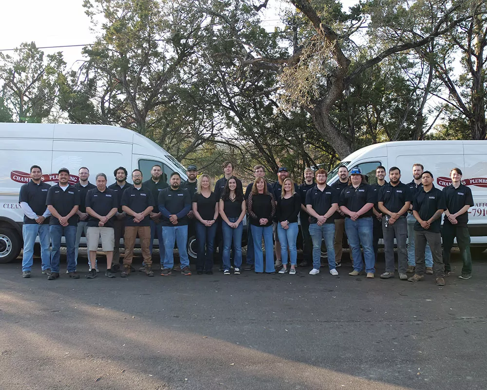plumbing company team in from of chambliss plumbing vans. Full team picture